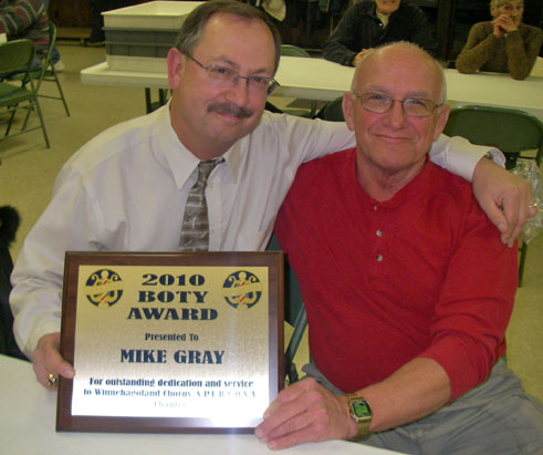 Mike Gray accepts B.O.T.Y. award from chapter president, Richard Voakes.