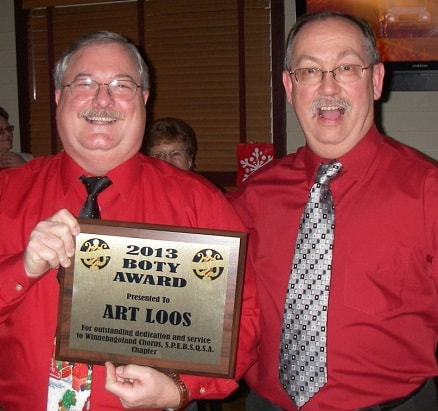 Art Loos accepts B.O.T.Y. award from chapter president, Mike Gray.