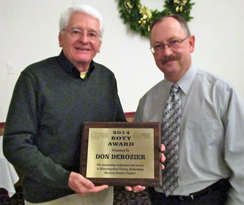 Don Derozier accepts B.O.T.Y. award from chapter president, Mike Gray.